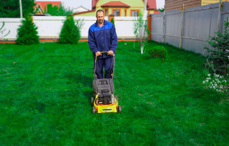 man-is-working-garden-mowing-grass-with-lawn-mower_221439-1131